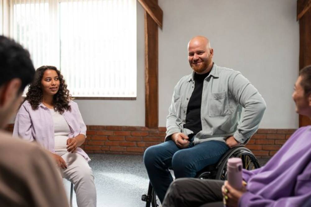 A diverse group, including individuals with disabilities, engages in a supportive group session at Drug Rehab in Columbus Ohio.