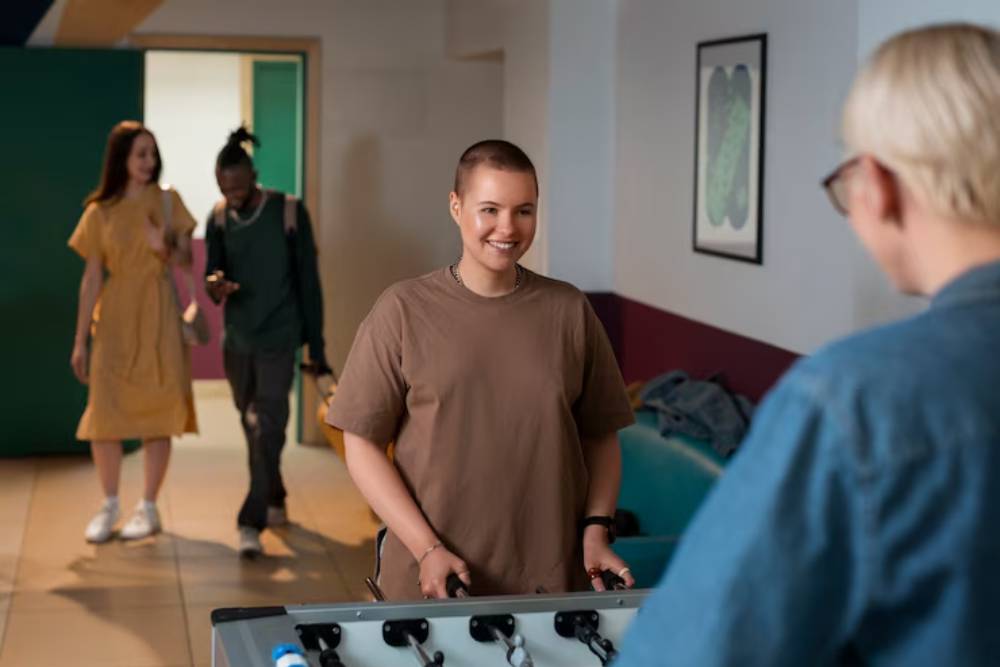 Clients at Drug Rehab in Columbus Ohio enjoy recreational activities like foosball to build social connections and support recovery.