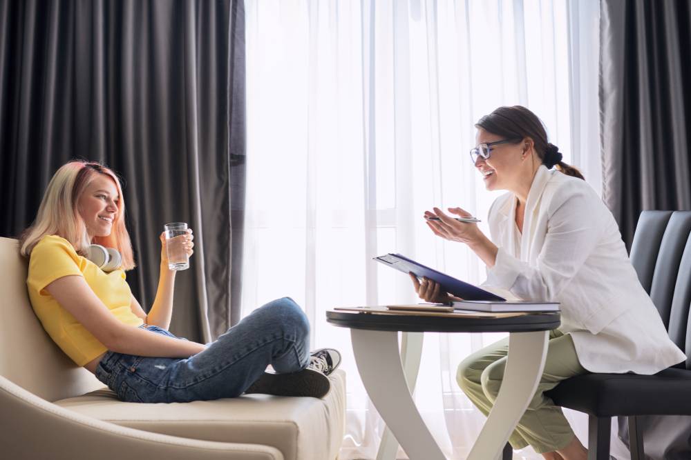 A therapist engages in a supportive one-on-one session with a young woman in a Partial Hospitalization Program in Columbus Ohio, helping her navigate recovery.