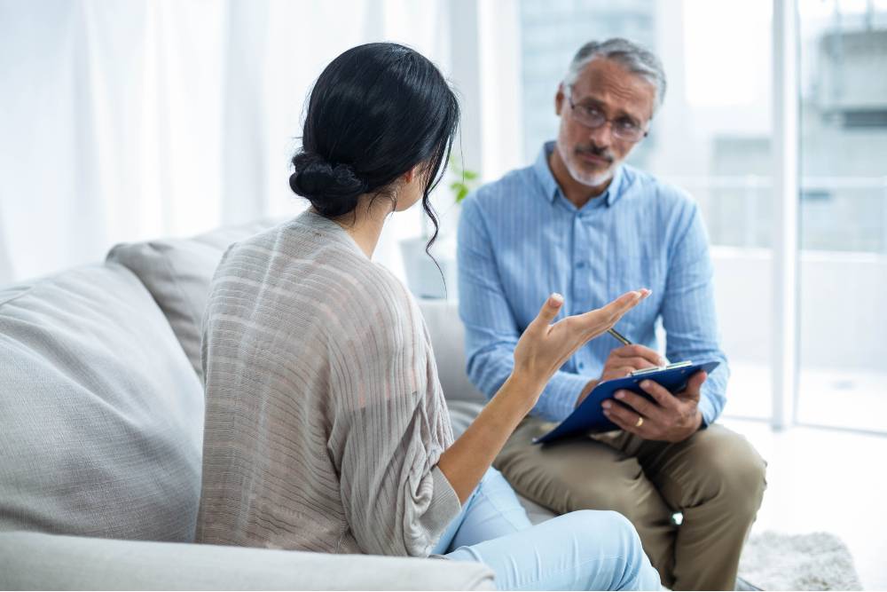 A patient speaks with a counselor during a private therapy session in an intensive outpatient program Columbus Ohio, focusing on mental health and recovery goals.