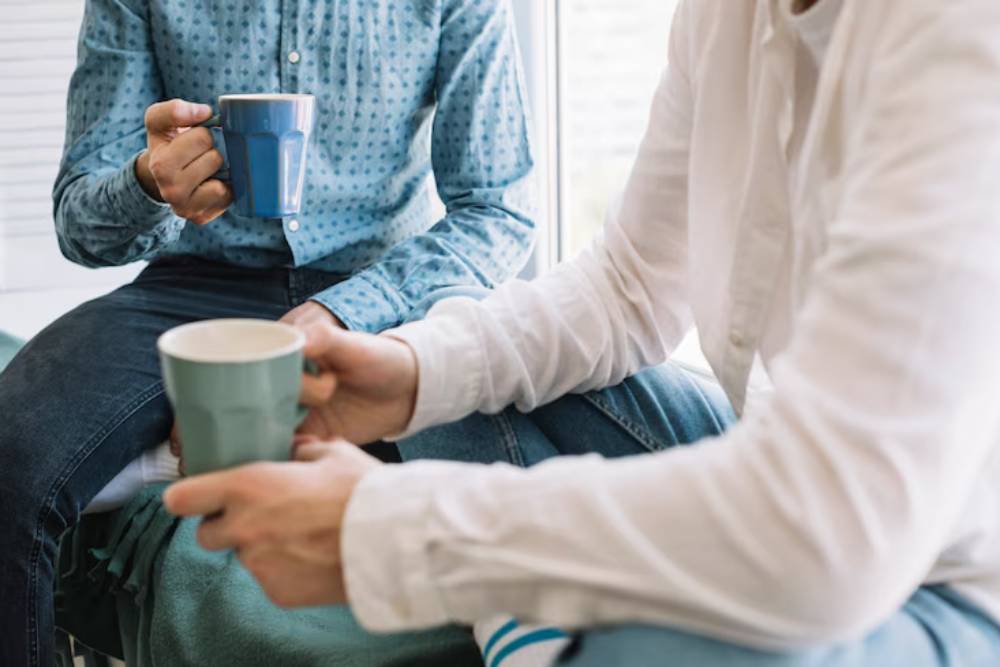 One-on-one conversation between patients at Outpatient Rehab in Columbus OH, building trust and support during a casual coffee break.